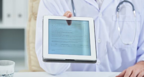 Doctor using secure medical form during a home visit