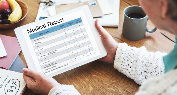 Home care provider filling out digital rounding sheet on tablet